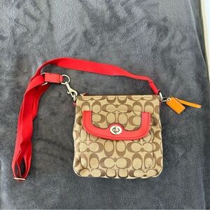 Coach Signature Crossbody Bag with burnt orange accents.